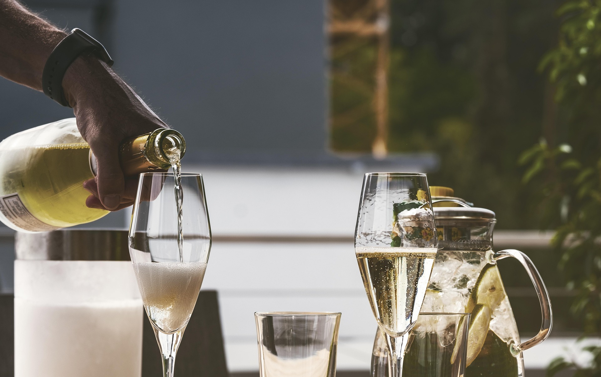 Pouring Champagne into sparkling wine flutes