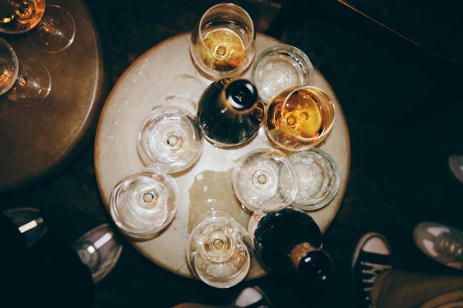 Overhead view of a table with many wine glasses over it